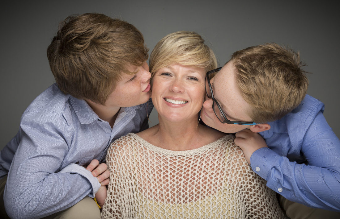 Photo of two sons kissing mother in south Florida
